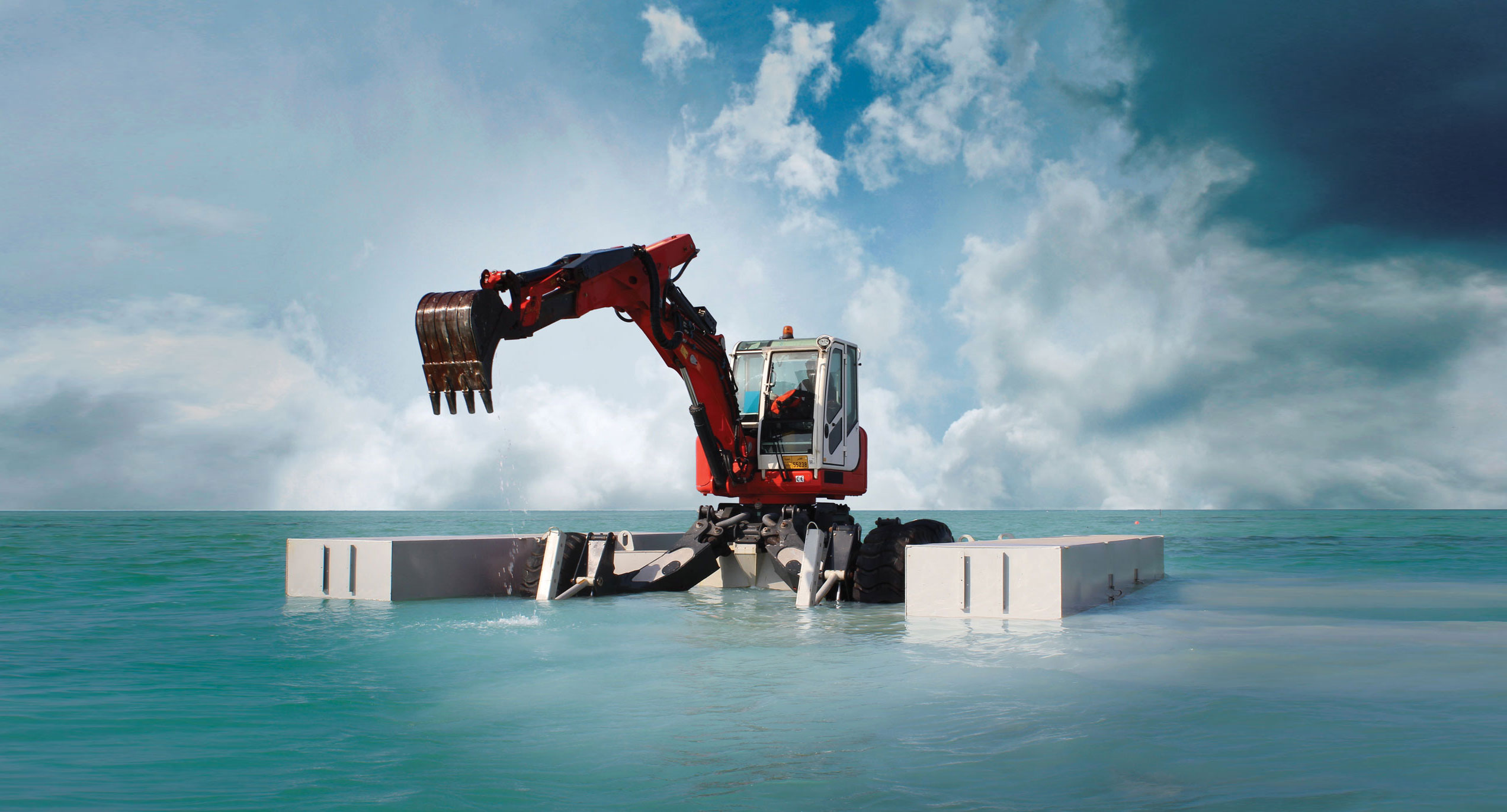 Thainex Aqua Spider amphibious excavator working in water dredging with pontoons.